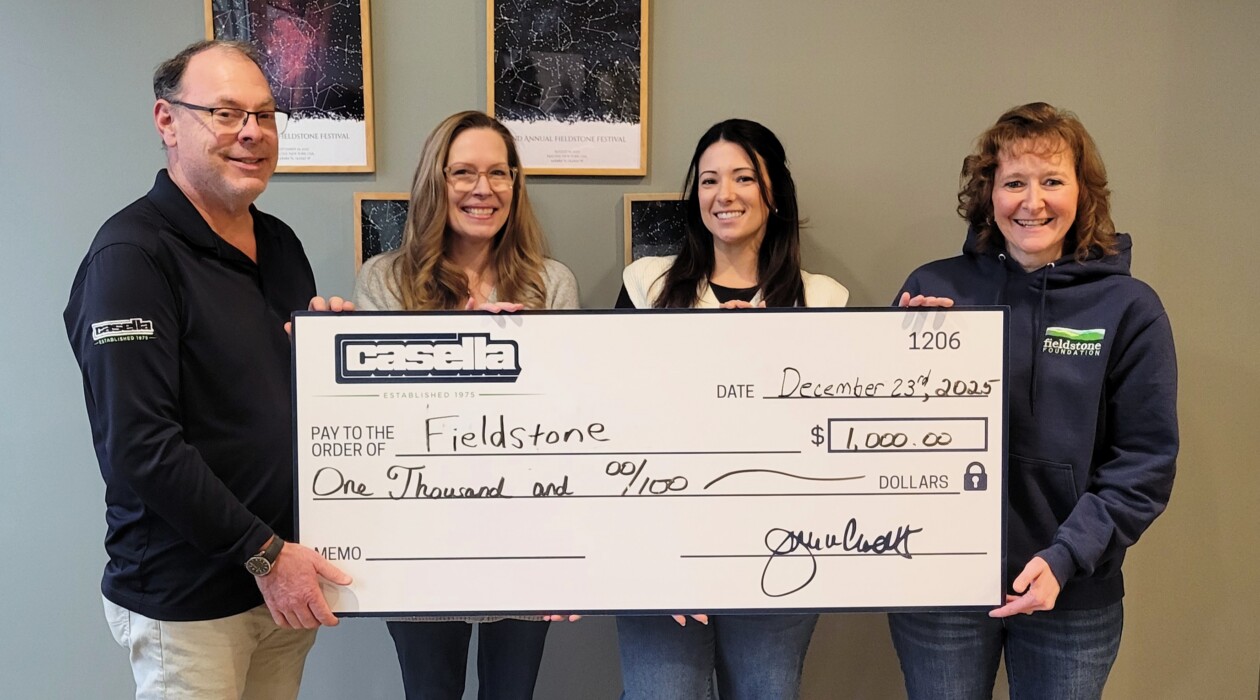 Casella donating to the Adopt-A-Child Program